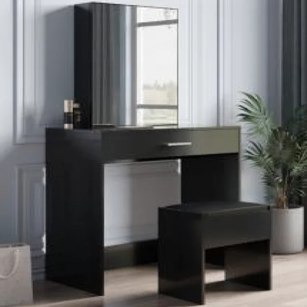 dark dressing table with a big mirror, drawers, and a soft stool.