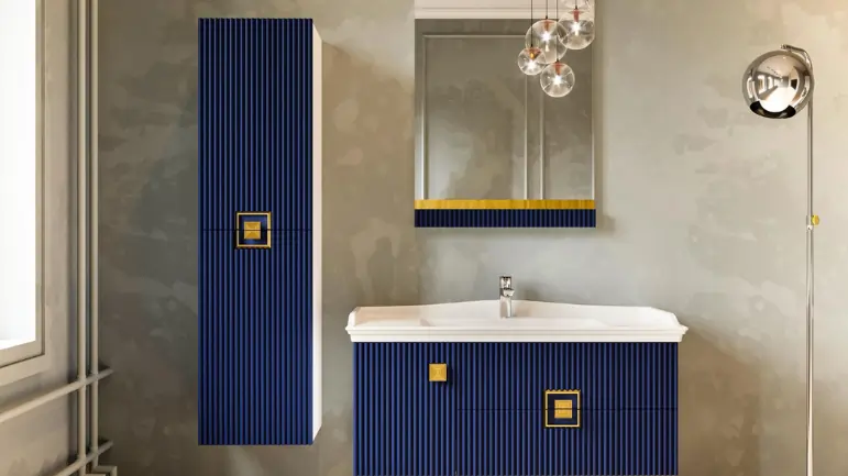 Modern bathroom with navy ribbed cabinets and gold handles, white sink, wall-mounted mirror, and contemporary lighting.